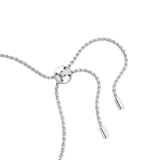 Pulsera plateada con hilera de cristales Swarovski talla baguette en tonos transparentes y morados, con cierre deslizante ajustable.