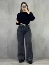 Pantalón de jean gris oscuro, corte wide leg, tiro alto y bolsillos frontales con cierre.