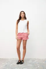 Chaleco blanco con botones al frente y sin mangas.