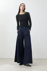 Pantalón de jean wide leg color azul oscuro con cintura alta y cinturón de cadena plateada.