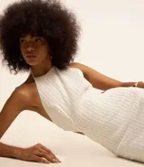 Vestido midi blanco texturizado con lazos en el cuello, espalda descubierta y abertura lateral.
