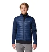 Chaqueta híbrida Columbia para hombre, color azul marino, con cuerpo acolchado y mangas de softshell. Presenta cierre frontal completo, cuello alto y logo de Columbia en el pecho.