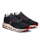 Championes urbanos negros con detalles en rojo y suela beige con tecnología CloudTec.