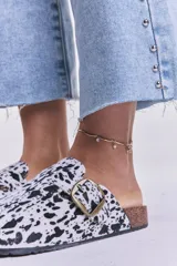 Zueco abierto con estampado animal print blanco y negro, hebilla metálica dorada y plantilla anatómica.