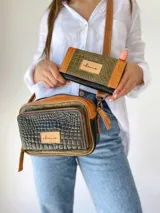 Bandolera de cuero con estampado de cocodrilo en tonos verde, marrón y negro. Tiene correa larga regulable, bolsillo interior y exterior.