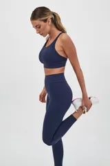 Top deportivo color verde militar con espalda cruzada en cuatro tiras y almohadillas removibles.