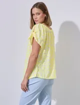 Blusa labrada de color amarillo, con escote redondo elastizado y hombros con abertura anudada, de la marca Zac & Rachel.