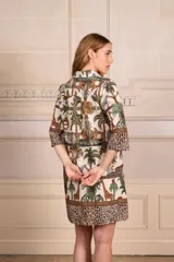 Vestido camisero corto de algodón con estampado de animales de la selva, cuello camisero, mangas 3/4 y cierre frontal con botones.