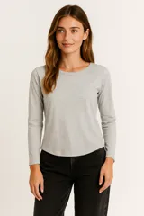 Remera de manga larga, color gris melange, con cuello redondo y corte ajustado al cuerpo.