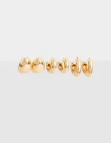 Set de tres pares de aros dorados tipo argolla con diferentes diseños chunky.