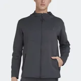 Campera deportiva con capucha y cierre frontal, color gris oscuro, con logo de Le Coq Sportif en el pecho y bolsillos laterales con cierre. Presenta paneles con costuras diagonales en el frente.