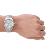 Reloj Emporio Armani modelo AR60076, con caja de acero plateado de 41mm y esfera blanca sunray. Movimiento automático de tres agujas con fechador. Correa de acero inoxidable plateado con cierre desplegable tipo mariposa. Resistente al agua hasta 50 metros.