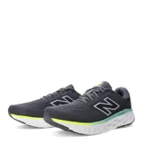 Championes New Balance Evoz Fresh Foam para hombre, color gris oscuro con detalles en verde lima y celeste en la entresuela. Presentan el logo 'N' plateado en el lateral y tecnología Fresh Foam.