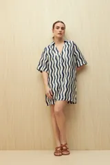Vestido corto con estampado de rayas onduladas en blanco y azul, cuello tipo solapa y escote en V.