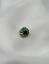 Caravana circular de resina dorada con strass turquesa y cristal. Se vende por unidad.