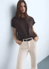 Jeans de tiro medio color beige, con cierre de cremallera y botón, trabillas, cinco bolsillos, bajo deshilachado y estilo flare. Confeccionados en tejido de algodón elástico.