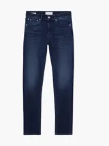 Jeans skinny de denim azul oscuro, tiro bajo, con cinco bolsillos y cierre de cremallera. Confeccionado con algodón reciclado y elastano.