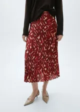 Falda midi plisada de tejido fluido con estampado abstracto en tonos rojo y beige.