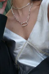 Vestido corto plateado con escote en V, sin mangas y bordado en el frente.