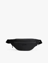 Riñonera negra Tommy Hilfiger con logo texturizado en el frente y cinta distintiva en el lateral. Cuenta con cierre de cremallera, correa ajustable de textil trenzado y bolsillo interior con cremallera.