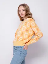 Sweater de punto con diseño jacquard de flores, de manga larga y cuello a la base.