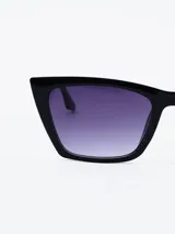Lentes de sol negros con forma de ojo de gato y lentes degradadas en tonos violeta.