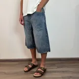 Bermuda de jean azul de corte ancho y largo a la rodilla.