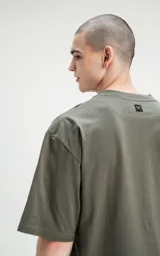 Remerón de corte cropped en color verde militar, con diseño relajado y mangas cortas.