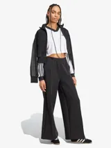 Top corto blanco de manga larga con cuello en V y ribete negro. Presenta las tres rayas características de Adidas en las mangas y el logo bordado en el pecho.