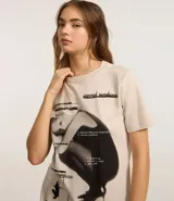 Remera de algodón color crema con estampa frontal de Ariana Grande y texto en negro.