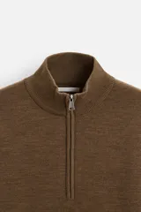 Jersey azul marino de punto suave, corte regular, cuello alto con cremallera frontal, manga larga y terminaciones en rib.