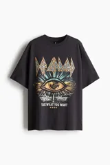 Remera negra de corte amplio con estampado de la banda Def Leppard, con un ojo y la frase "Take what you want".