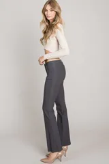 Pantalón negro de corte recto, tiro bajo y pierna angosta.