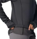 Buzo polar Columbia de mujer, color gris, con media cremallera frontal, cuello alto, mangas largas con orificios para pulgares y bolsillo con cremallera en la manga izquierda.
