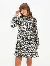 Vestido corto con estampado animal print, cuello alto fruncido y mangas largas abullonadas.