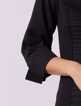 Camisa negra de algodón con cuello con solapa, abertura central con botones, delantera tableada y mangas 3/4. Laterales elastizados.