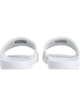 Ojotas blancas de Calvin Klein Jeans con logo CK en la tira.