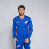 Buzo deportivo Umbro de manga larga, color azul rey, con cuello redondo y detalles laterales en rojo y blanco. Lleva el escudo del Club Nacional de Football en el pecho izquierdo y el logo de Umbro en el derecho.
