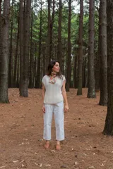 Chaleco color crudo tejido a mano en hilado 100% baby alpaca, con cuello tipo bote, hombros anchos, puntos calados en frente y espalda, y tajos laterales en el bajo.