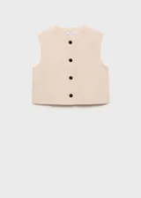 Top color crema, de corte crop, cuello redondo y sin mangas. Cierre frontal con botones y forro interior.