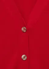Cárdigan rojo de tejido de punto fino con cuello en pico, cierre frontal con botones y mangas largas.