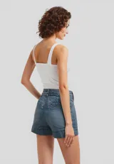 Short de jean color blanco, de tiro alto, corte holgado y bolsillos delanteros.