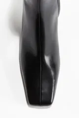 Botines negros de cuero con taco bloque, punta cuadrada y cierre lateral.