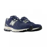 Championes New Balance modelo 1906R, color azul marino con detalles en gris y blanco. Presentan una construcción en malla transpirable con superposiciones sintéticas y entresuela con tecnología N-ergy.
