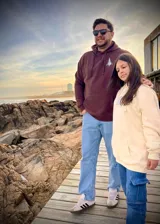 Hoodie marrón con capucha, corte oversize y estampado de paisaje montañoso en la espalda con la frase "Never Stop Exploring".