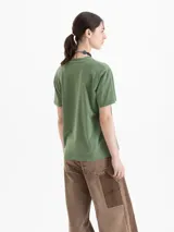 Remera verde de algodón pima, de mangas cortas, cuello redondo y fit amplio. Presenta una estampa frontal de tres cerezas en tonos rojos y blancos.