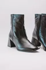 Botas plateadas de cuero con caña media, cierre lateral con cremallera y tacón geométrico.