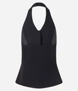 Chaleco negro con frente única, corte peplum, estructura sastre y cierre frontal con botones.