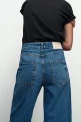 Jeans de tiro medio, color azul denim, con cinco bolsillos, corte wide leg y largo extra.