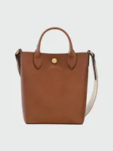 Bolso tote Longchamp modelo Épure XS, color marrón cuero, con correa larga de tela color crudo.